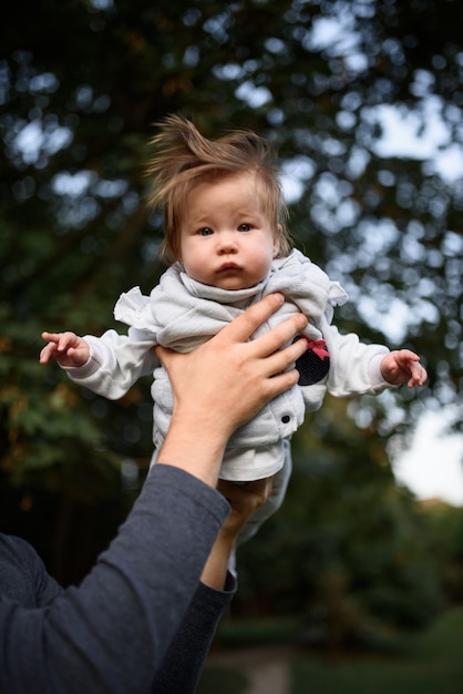 Young father having fun with his little daughter in park