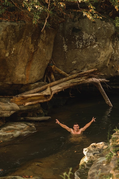 A young father and his sons bathe in a mountain river