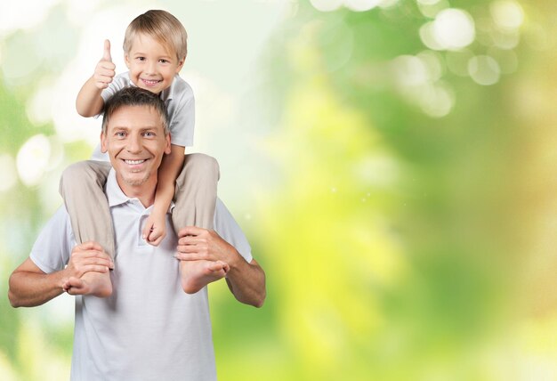 Young father with son on green background