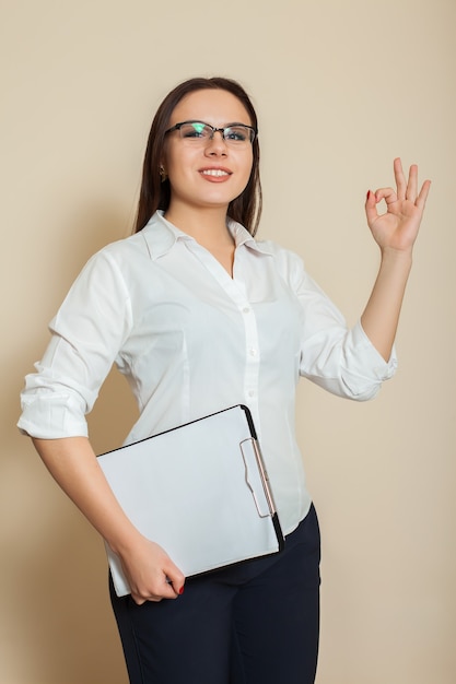 Young female accountant shoes OK sign