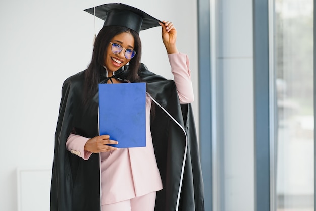 Young female african american student with diploma.