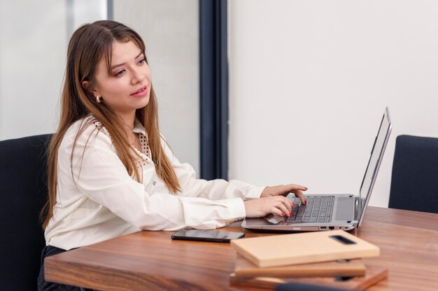 Young female Architect working in her dining room with her laptop