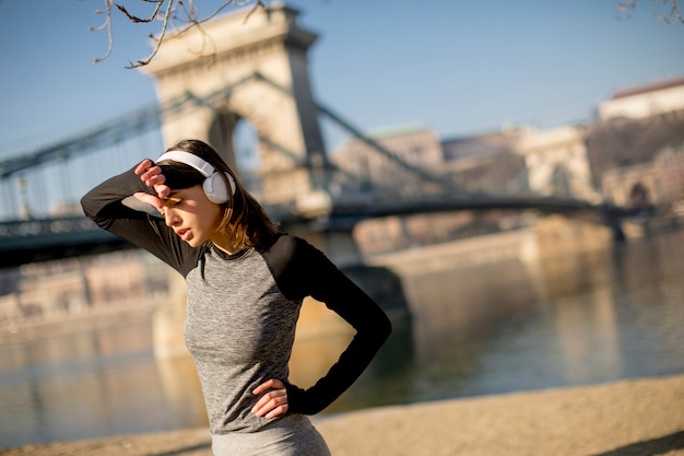 Young female athlete taking break from running workout