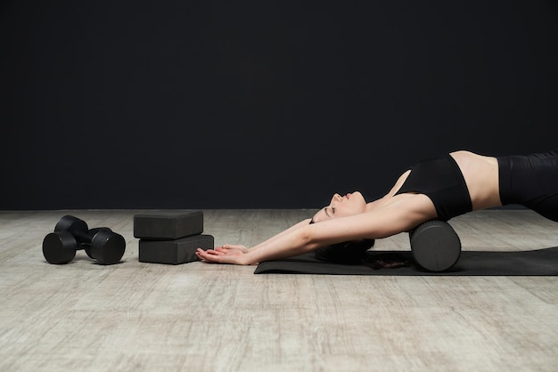 Young female athlete working out training doing fitness indoors