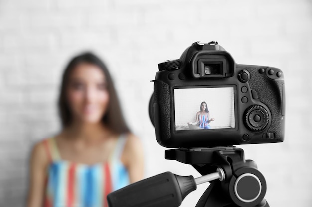 Young female blogger on camera screen