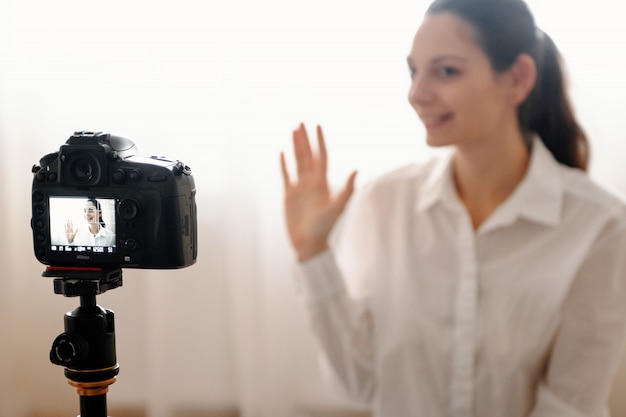 Young female blogger with camera