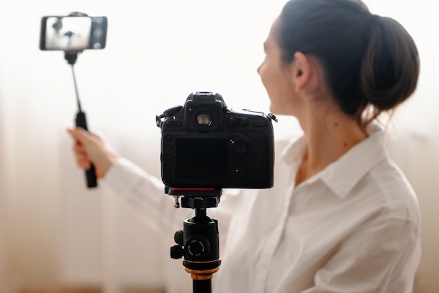 Young female blogger with camera