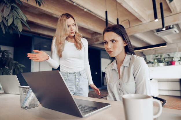 Young female boss scolding her female subordinate for bad work results