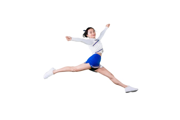 Young female cheerleader jumping in the studio