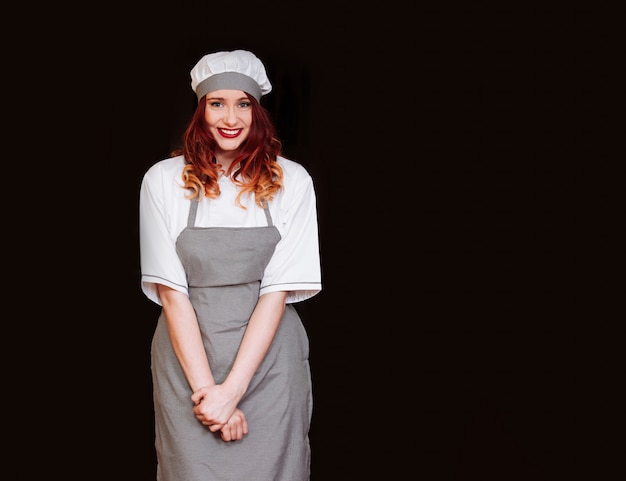 Young female chef with gray apron