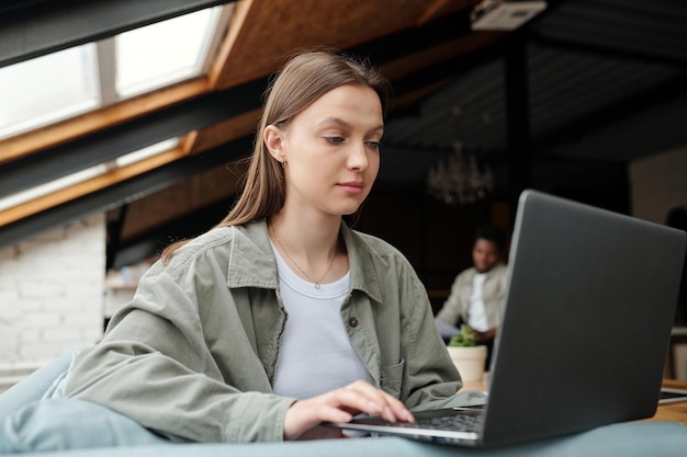 Young female chief executive officer looking at laptop screen