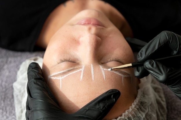 Young female client going through a microblading procedure