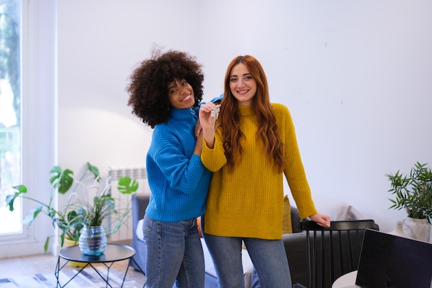 Young female couple moving into their new flat to live together