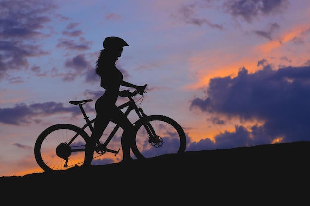 Photo young female cyclist cycling on rural road side view