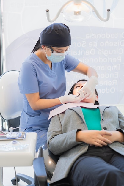 Young female dentist performed dental procedure on a patient so that she can recover as soon as possible.