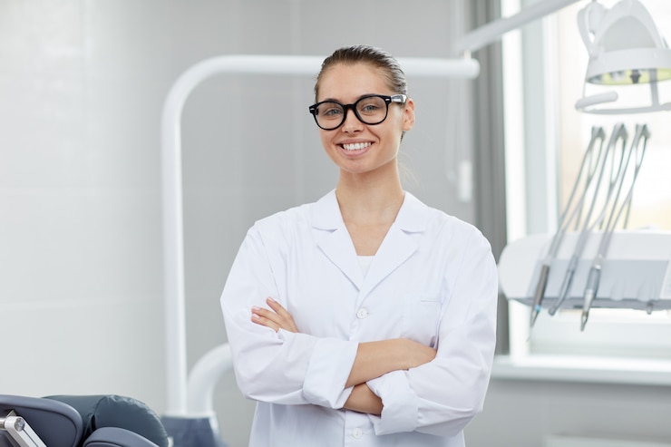 Photo young female dentist posing in office