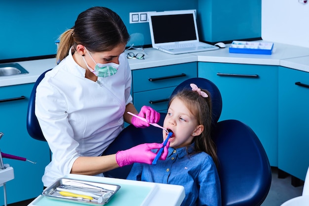 Young female dentist working in her office