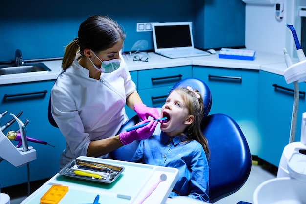 Young female dentist working in her office