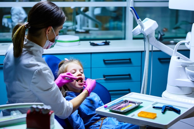 Young female dentist working in her office