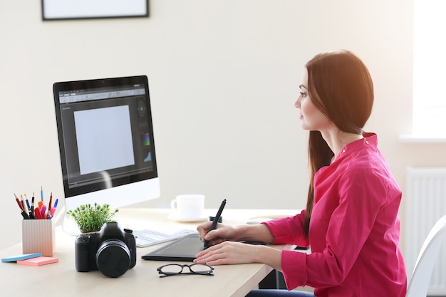 young female designer working in office