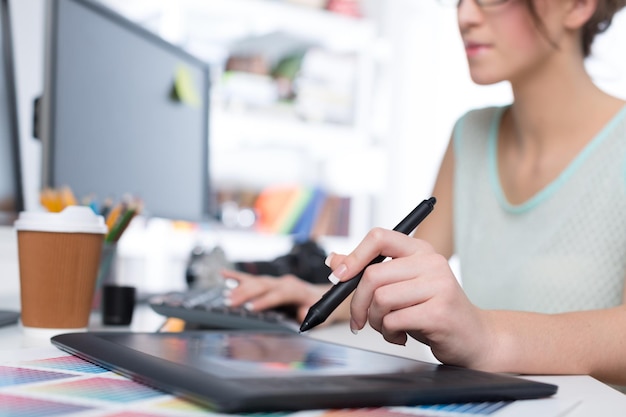 Young female designer at workplace