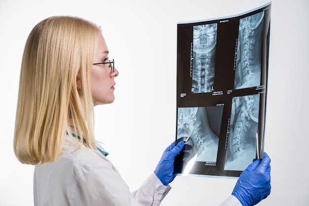 Young female doctor examining x-ray