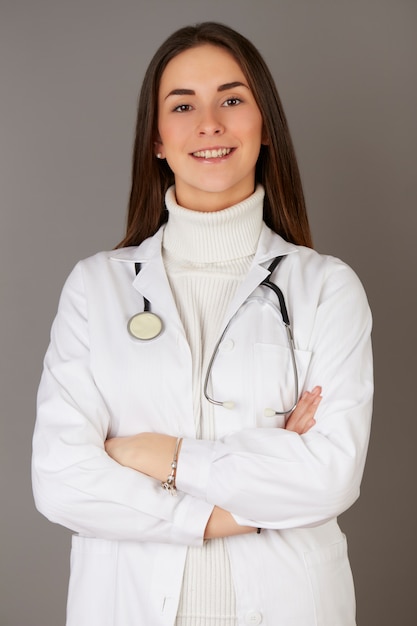 Young female doctor - gray background