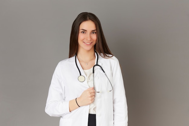 Young female doctor - gray background