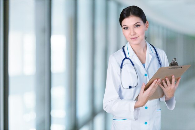 Young female doctor holding clipboard