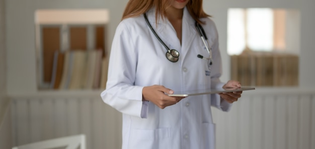 young female doctor holding tablet in hospital