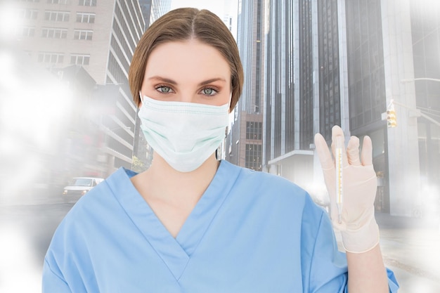 Young female doctor holding a thermometer against road turning into arrow