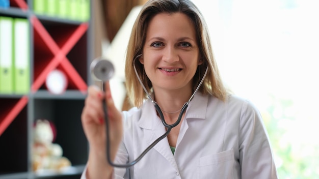 Молодая женщина-врач в больнице держит стетоскоп врача медицинского здравоохранения и страхования