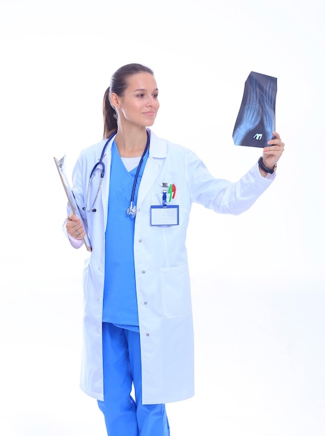 Young female doctor looking at the xray picture isolated on white background Woman doctor