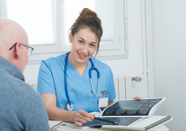 Young female doctor in the office with her patient