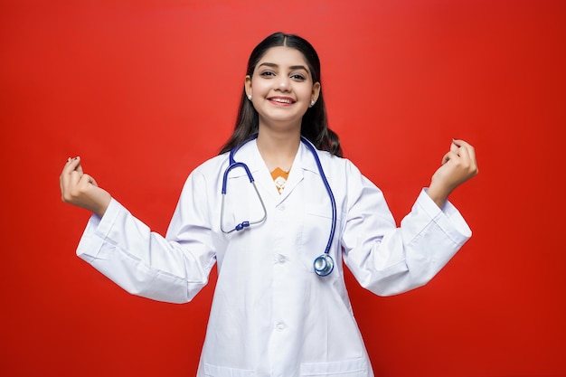 young female doctor smile wearing coat and stethoscope around neck indian pakistani model