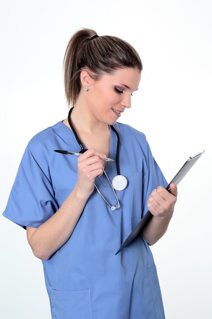 Young Female doctor in uniform with pen and stethoscope