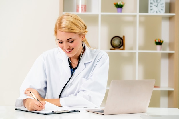 Young female doctor working in hospital office.