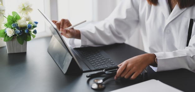 young female doctor working on medical charts and document in her office