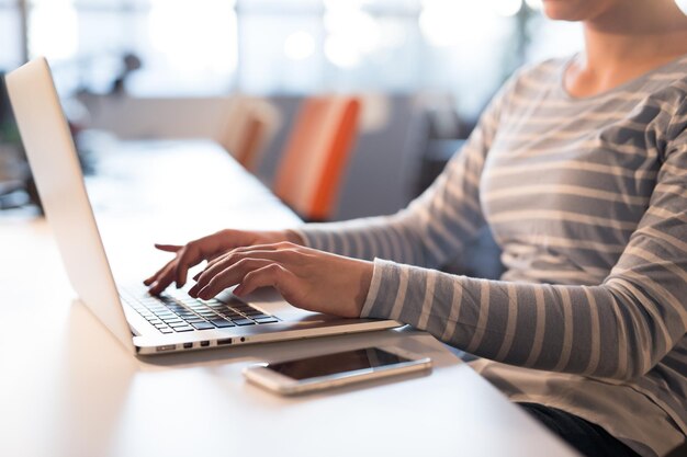 Young female Entrepreneur Freelancer Working Using A Laptop In Coworking space