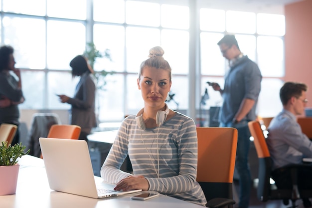 Young female Entrepreneur Freelancer Working Using A Laptop In Coworking space