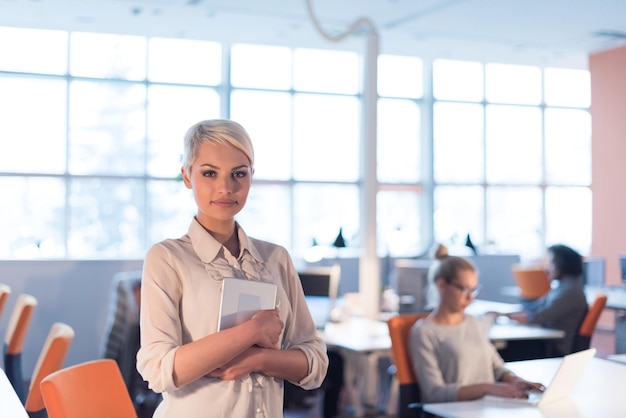 young female entrepreneur working on digital tablet in night office