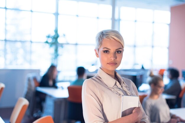 young female entrepreneur working on digital tablet in night office