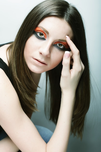 young female face with bright fashion multicolored make-up