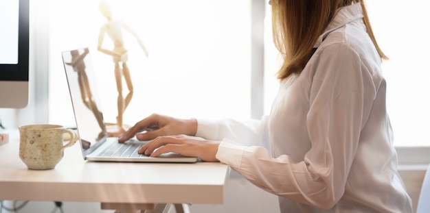 Young female freelancer working at comfortable workspace 