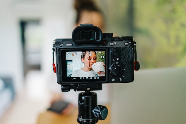 young female freelancer working on laptop She is creating content with camera and working on laptop