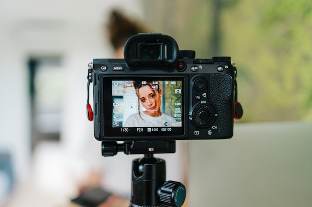 young female freelancer working on laptop She is creating content with camera and working on laptop