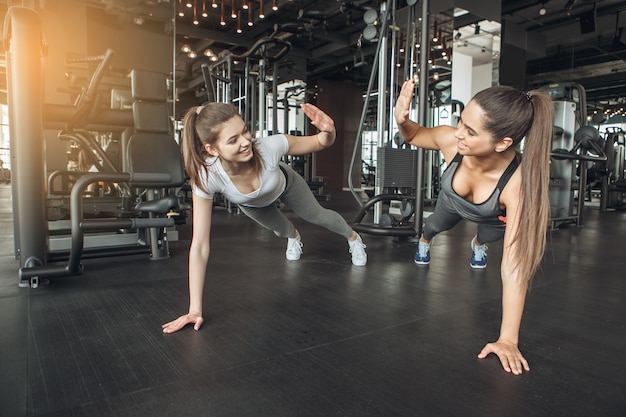 Giovani amiche si esercitano nell'allenamento in palestra