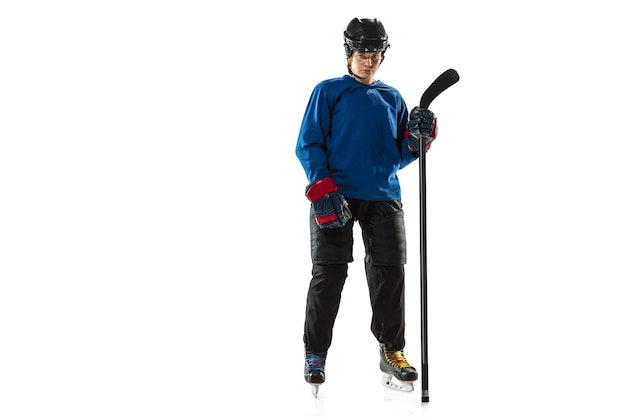 Young female hockey player with the stick on ice court