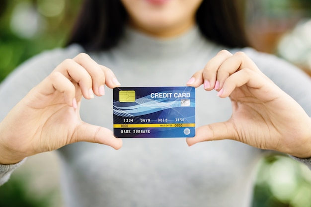 Photo young female holding credit card