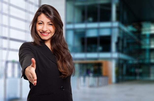 Young female manager giving you a handshake